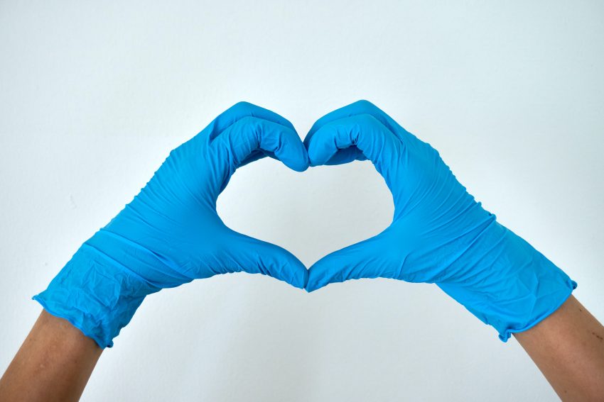 hands in gloves making heart shape
