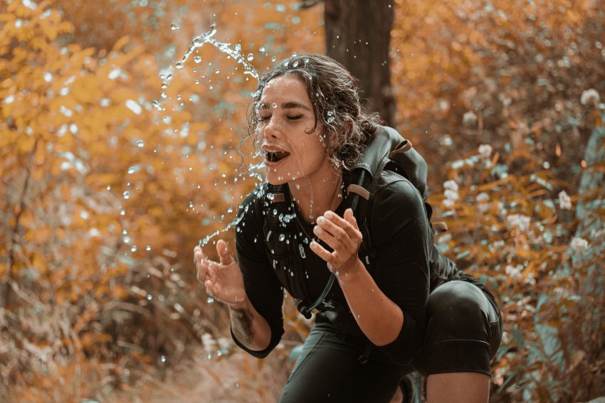 woman splashing face with water