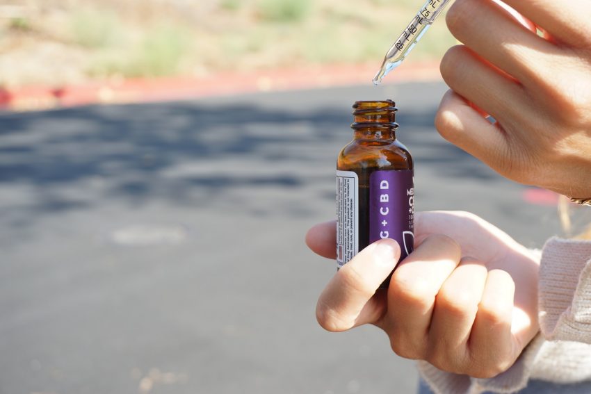 closeup of person holding CBD bottle, what is CBD?