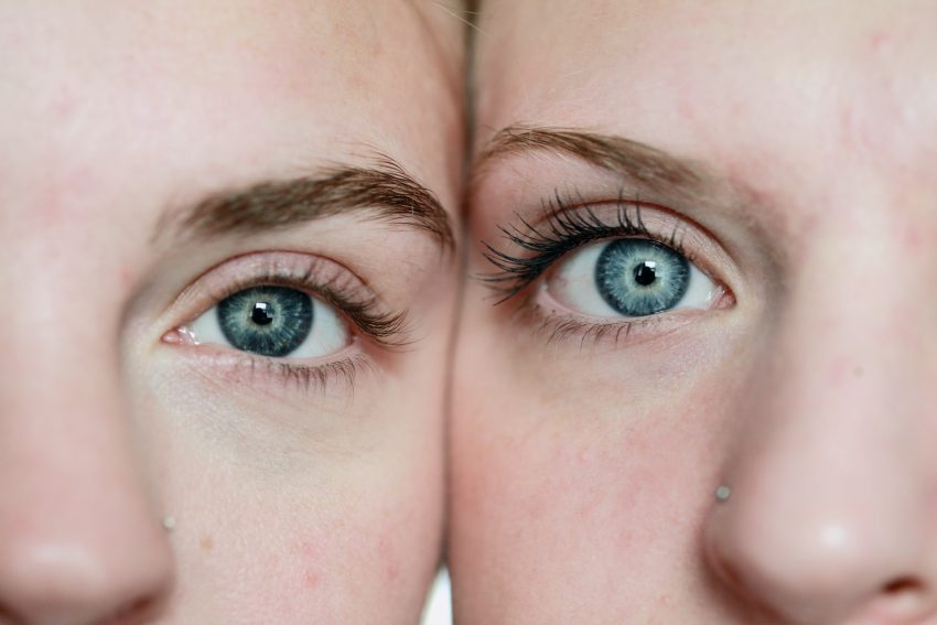 closeup of two people, their faces touching side by side, both looking at the camera, suitable skin types for salicylic acid